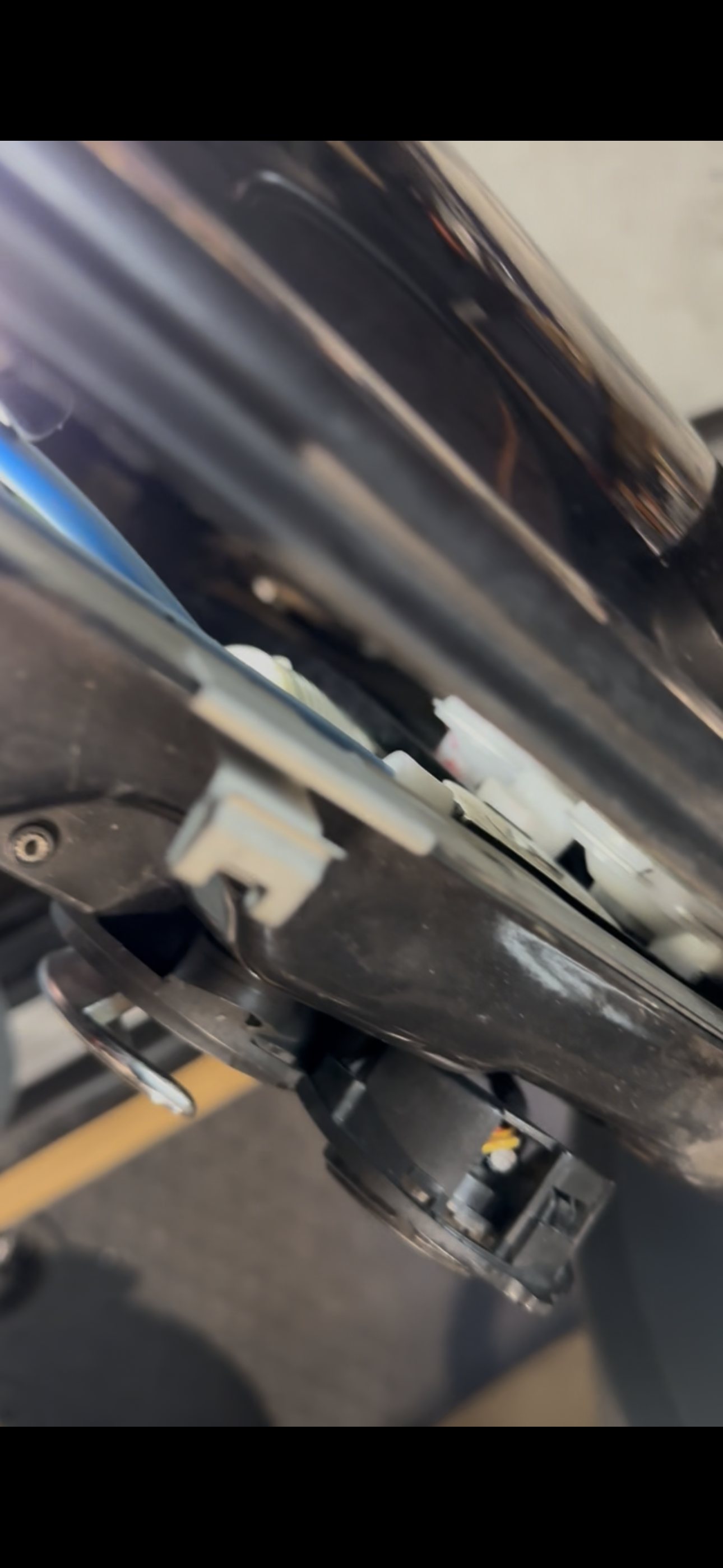 Window regulator rail and cable guide visible through the open driver door structure