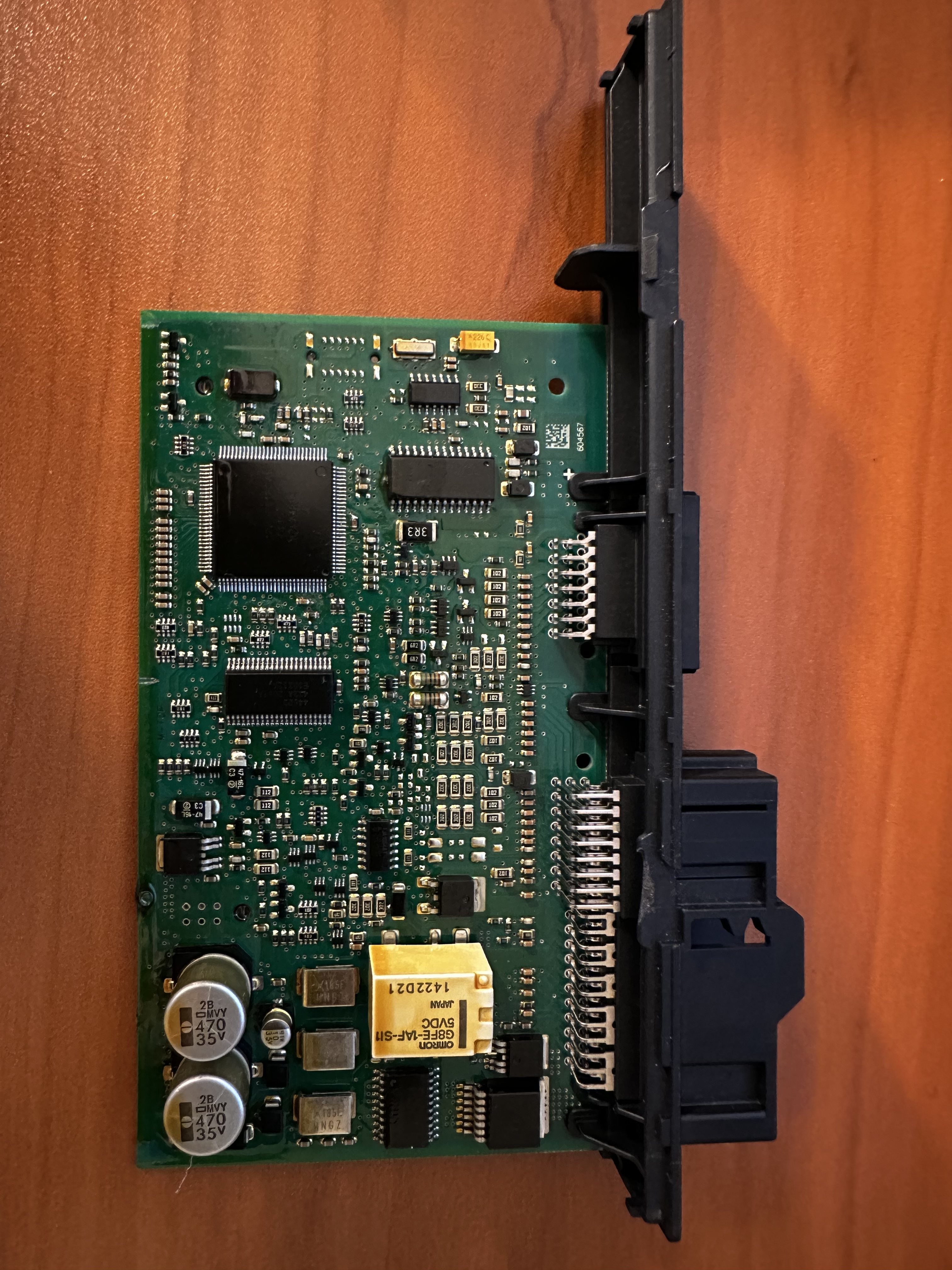CAS3 circuit board removed from its housing, showing the connector pin headers, microcontroller, memory devices and a relay