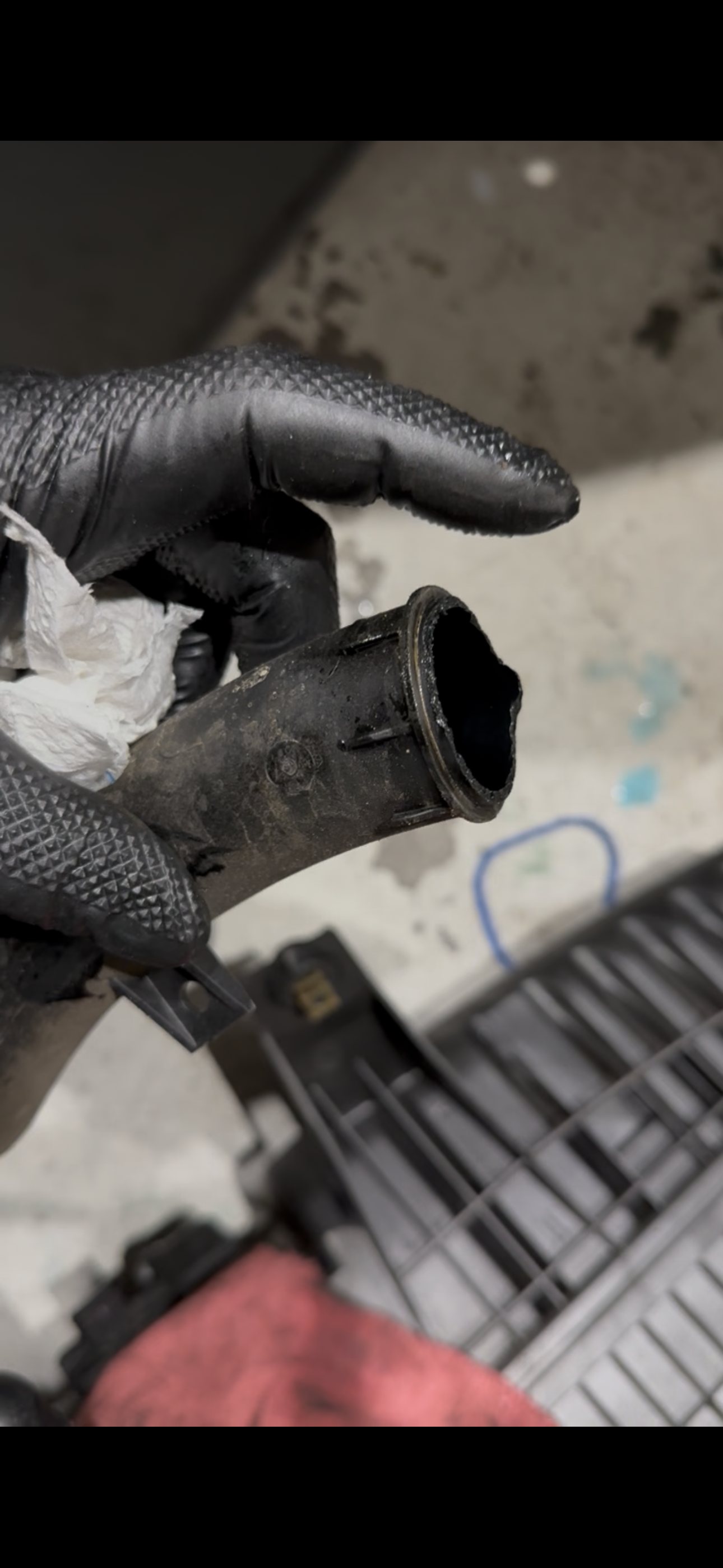 Close view along the sealing edge of the crossover pipe, with the plastic rim broken away on one side of the opening