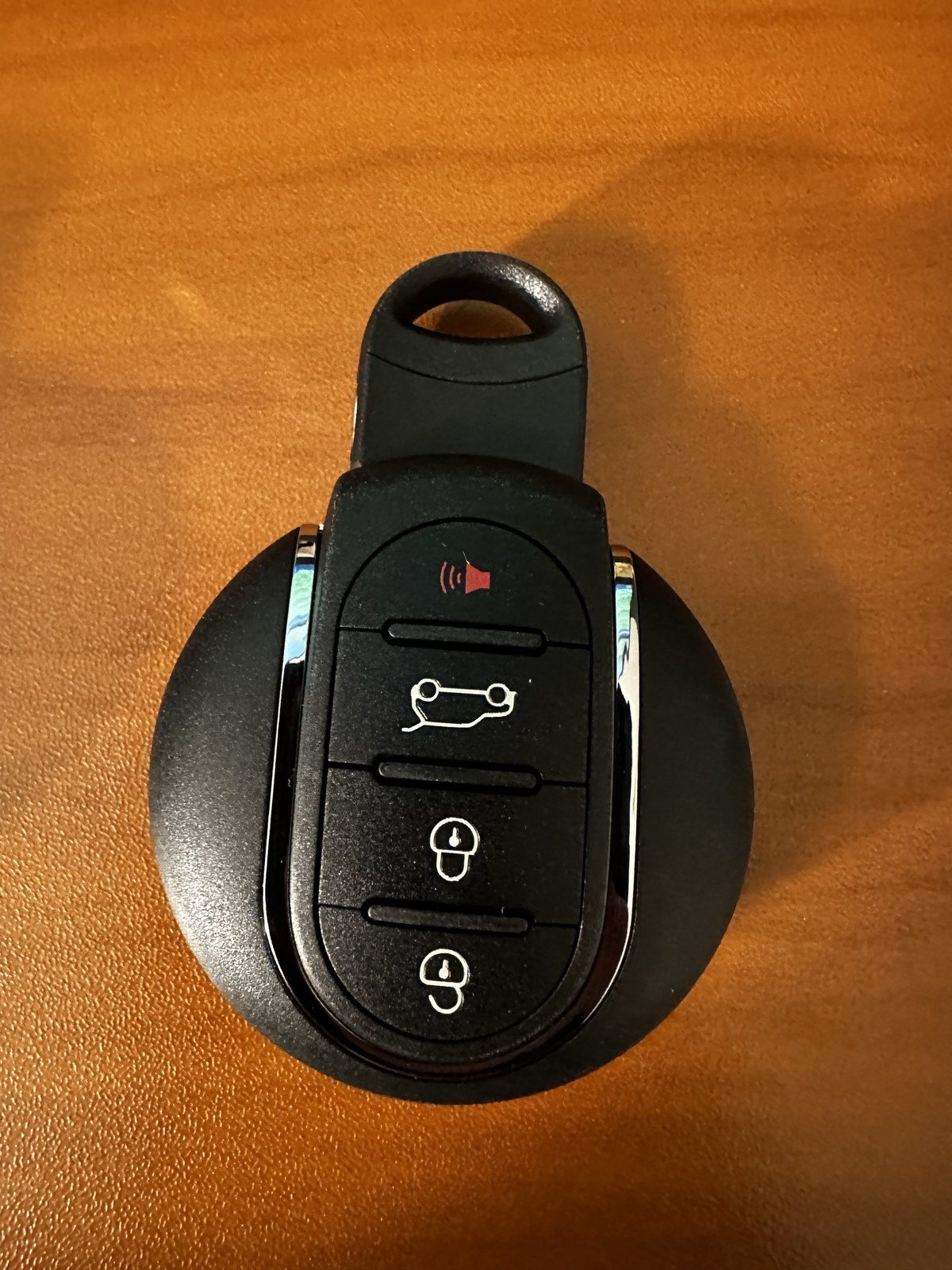 Third-generation MINI key fob with a red panic button above boot release, unlock and lock buttons