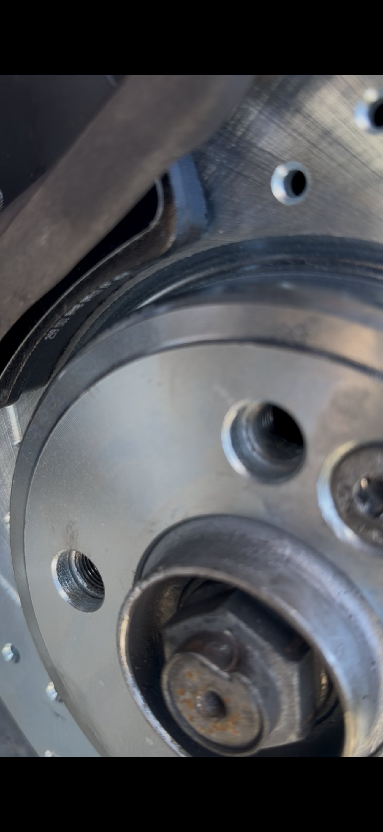 Close-up of the front brake rotor seated against the wheel hub on a MINI Cooper Coupe S
