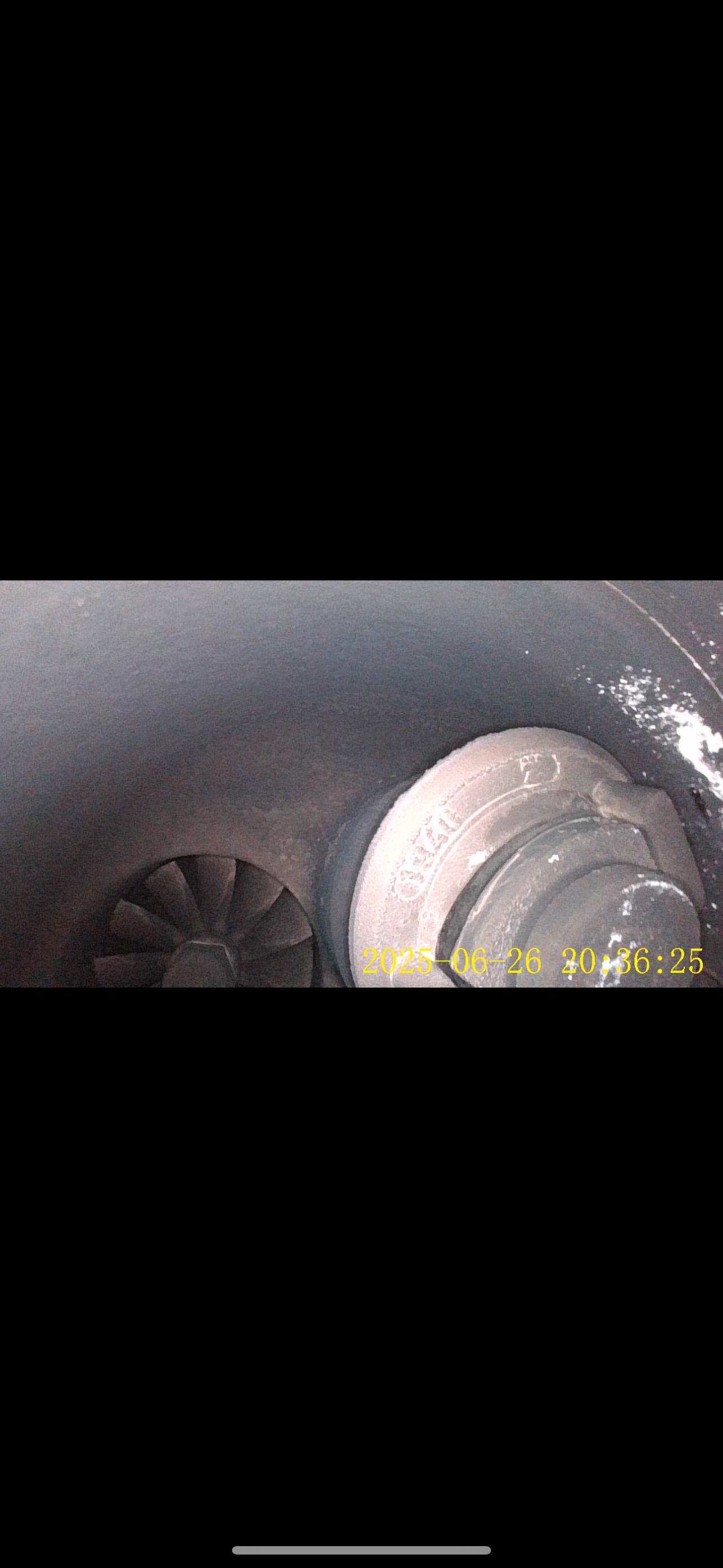 Inspection-camera view inside the turbocharger showing the turbine wheel and wastegate valve area