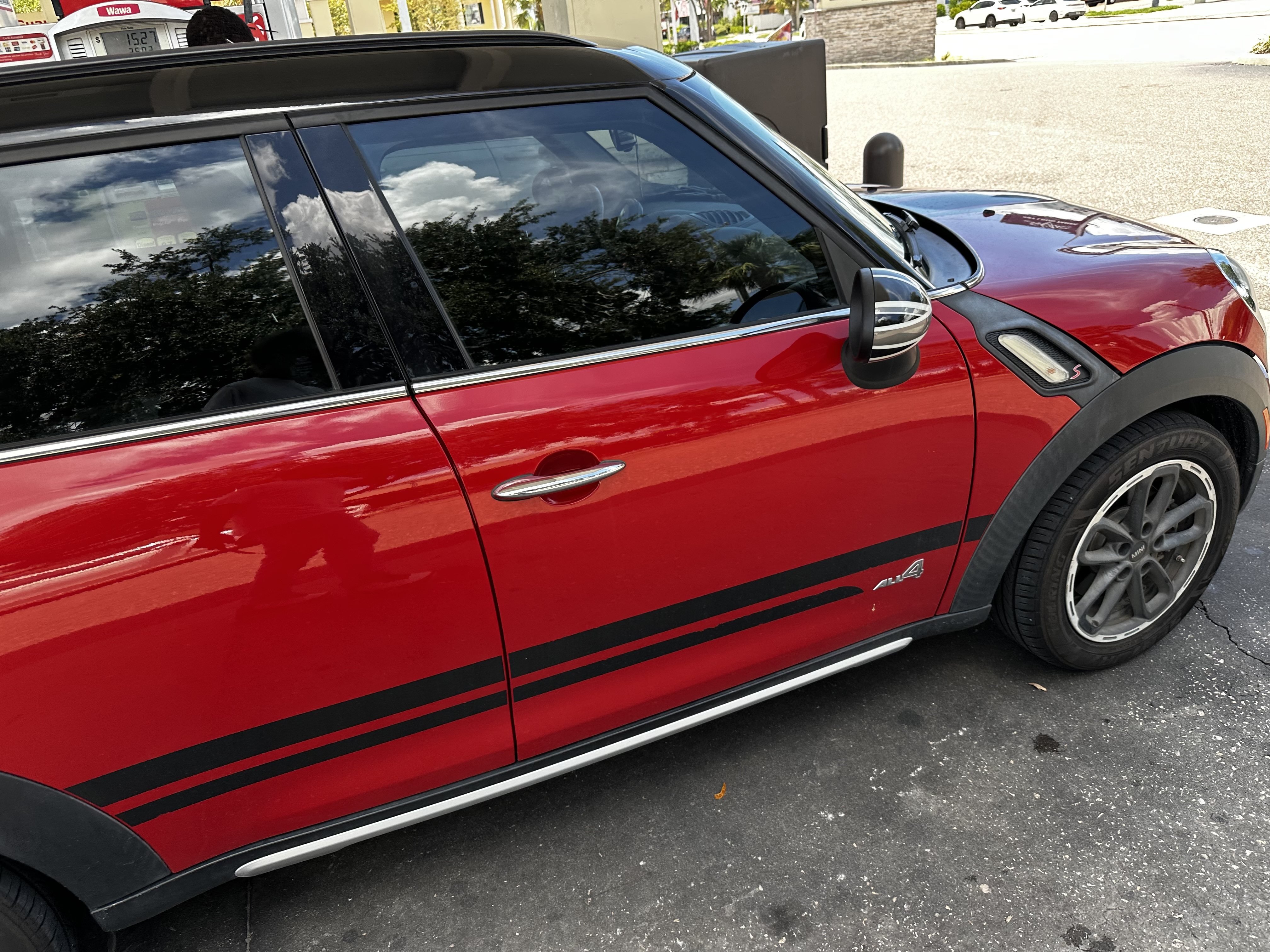 Red 2016 MINI Countryman S with black bonnet stripes and an ALL4 badge on the lower door