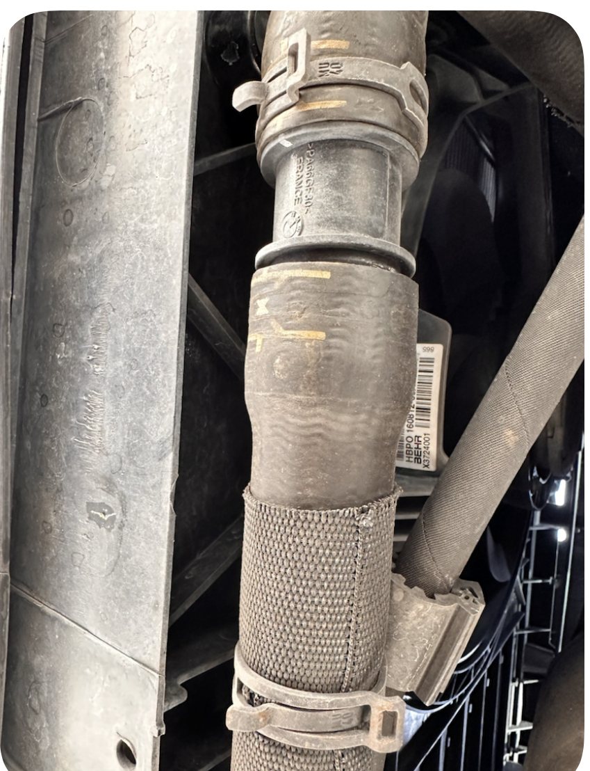 R60 Countryman coolant hose connection with the lower spring clamp displaced below the hose joint