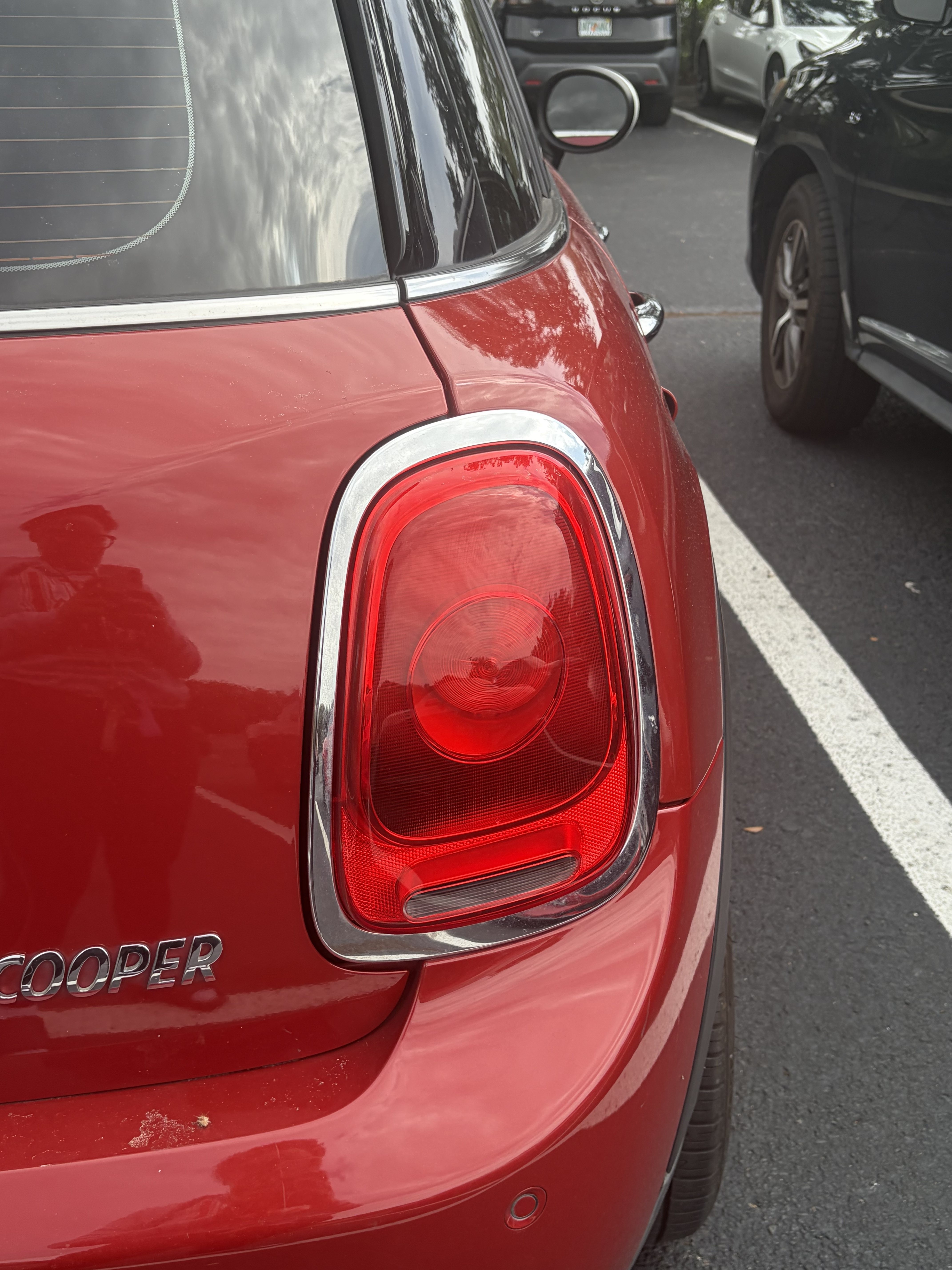 Close exterior view of the passenger-side rear lamp on the red 2018 MINI Cooper